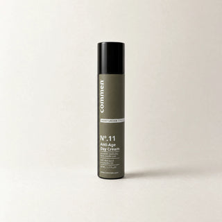 Commen Nº.11 Anti-Age Day Cream, a slim 50 ml airless pump bottle with an olive label, standing on light paper.