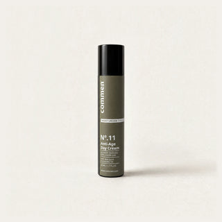 Commen Nº.11 Anti-Age Day Cream, a slim 50 ml airless pump bottle with an olive label, standing on light paper.