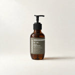 Commen Nº.16 Citrus Body Serum, a 270 ml amber pump bottle with an olive label, standing on light paper.