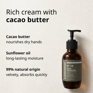 Commen Nº.18 Citrus Hand Cream lying on light paper, with cacao butter and sunflower oil in a rich cream.