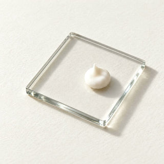 Commen Nº.11 Anti-Age Day Cream: a pea-size dot pressed between two glass plates into a smooth, even layer.
